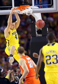 Mitch McGary #4 of the Michigan Wolverines dunks the ball against the Syracuse Orange.