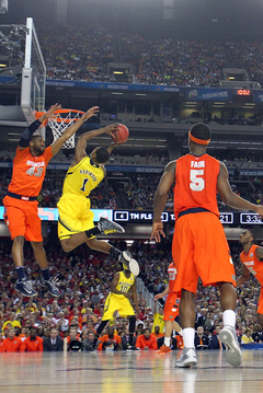 Glenn Robinson III #1 of the Michigan Wolverines puts the ball up to the basket against James Southerland #43 of the Syracuse Orange