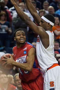 Flyers guard Vee Sanford looks for an opening while Fair obstructs his view. 