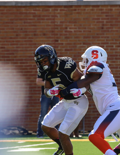Orville Reynolds is brought down by a Syracuse player. The Demon Deacons rushed for 71 yards on Satuday, 40 more than their season average. 