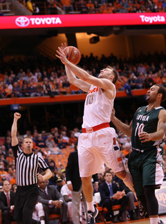 SU guard Trevor Cooney draws a foul as he elevates near the Orange's bench.