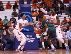 SU forwards Chris McCullough (left) and Rakeem Christmas (right) converge on a Loyola Greyhound in the paint.