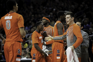 Point guard Kaleb Joseph (center) did not play in the key minutes of Syracuse's first two ACC games, but helped the Orange close out its third conference win Sunday. 