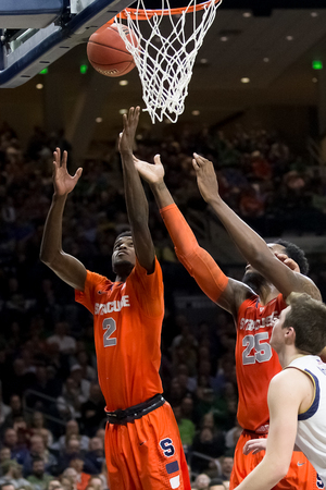 Syracuse forward B.J. Johnson vies for a ball with teammate Rakeem Christmas during the Orange's 65-60 upending of No. 9 Notre Dame on Tuesday night.