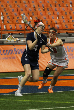 SU's Mallory Vehar defends against UConn attack Katherine Finkelston on Wednesday night. The Orange defense didn't clear the ball efficiently, but Syracuse still stayed undefeated.