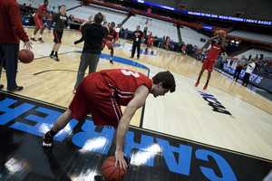 Dave Levitch, a guard for the University of Louisville, warms up on the Carrier Dome floor during open practice on Thursday. In preparation for the Sweet 16 games being played Friday, the Carrier Dome court and stands underwent a series of changes.