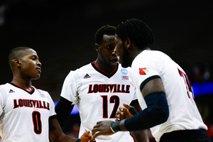(From left) Terry Rozier, Mangok Mathiang and Montrezl Harrell celebrate during Louisville's 75-65 win over N.C. State during the Sweet 16 on Friday night in the Carrier Dome. 