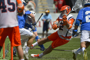 Syracuse midfielder Derek DeJoe attempts an off-balance shot from in front of the cage. The junior scored a man-up goal in the second quarter as SU battled back from a slow start.