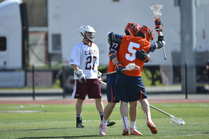 Nicky Galasso celebrates with Henry Schoonmaker after a Syracuse goal on Saturday. Two late Galasso goals gave the Orange some breathing room, as No. 1 Syracuse held on in a 9-7 win over No. 13 Colgate.