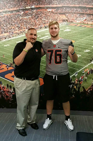 Sam Heckel poses with Syracuse guards and centers coach Joe Adam. Heckel will announce his college decision at 3 p.m.