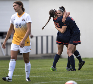 Alexis Koval (17) and Stephanie Skilton celebrate a second-half goal. Koval assisted on both SU tallies in a 2-1 win.