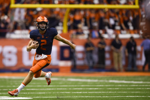 Eric Dungey scampers with the ball during Friday's game against Rhode Island. The true freshman replaced senior Terrel Hunt behind center in the first quarter.