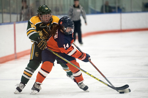 Syracuse forward Melissa Piacentini tries to box out a Clarkson player going for the puck. The Orange fell 3-1 in its first game of the season.