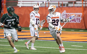 Syracuse midfielder Nick Mariano (23) has added an extra dimension to the Orange's offense by connecting on passes from attack Dylan Donahue (17).