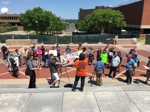 About 40 Syracuse University community members gathered in front of the Hall of Languages to protest the University Place promenade.