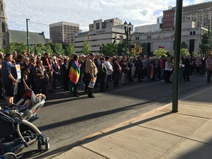 Hundreds of Syracuse community members — many of them bearing the gay pride flag — gathered outside of Syracuse City Hall on Monday to mourn the victims of the Orlando shooting.