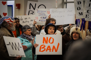 Hundreds protested Trump's travel and refugee ban Sunday night at Syracuse Hancock International Airport.
