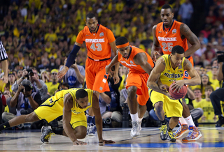 James Southerland #43, C.J. Fair #5 and Rakeem Christmas #25 of the Syracuse Orange reach for the ball against Trey Burke #3 of the Michigan Wolverines.