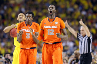 Baye Moussa-Keita #12 of the Syracuse Orange reacts after a play in the game against the Michigan Wolverines.