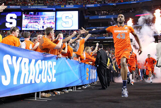 James Southerland runs out onto the court with the Orange before the game.