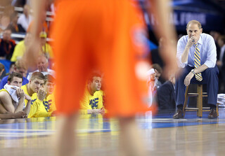 John Beilein looks on as play carries on at the other end of the court.