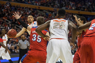 Ennis tries to scoop the ball into center Rakeem Christmas in a crowd of Dayton defenders. 