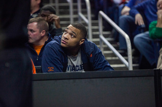 Syracuse center DaJuan Coleman, who is sidelined with an injury, stares on as his team struggles to separate itself from the Flyers. 