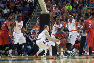 A crowd of SU defenders trap a Dayton player in the half court. 
