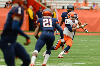 Quarterback A.J. Long scrambles in the open field. Long's mobility was limited on Saturday as quarterbacks played touch rules.