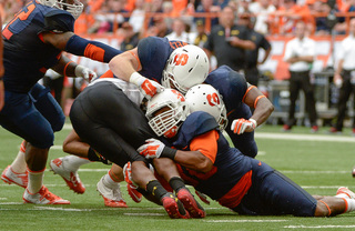 Syracuse players wrap up a Maryland ball-carrier during the Orange' 34-20 loss in the Carrier Dome Saturday. 