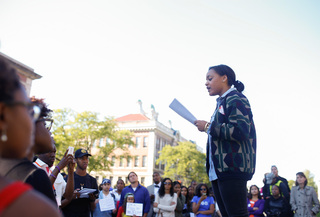 Anju Franklin, a senior biology and African American studies major, reads the list of demands to participants at the 