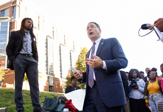 Eric Spina, vice chancellor and provost, speaks with protesters outside the Life Sciences building during the 