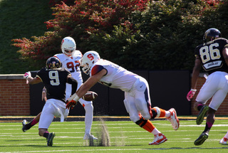 SU punter Riley Dixon staves off Kevin Johnson during the second half of SU's 30-7 win over Wake Forest. 