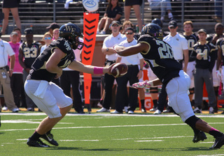 Dezmond Wortham takes a handoff. He finished with a team-leading 57 yards on the ground. 