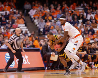 Johnson fights for the ball against an Owls player. The sophomore forward recorded a career-high in points and rebounds in the season opener.