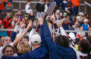 UConn players hoist the national championship trophy after beating Syracuse 1-0 in College Park, Maryland.