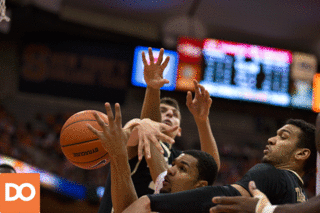 SU forward Michael Gbinije gives up his body in an unsuccessful attempt to grab a loose ball.