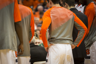 Syracuse's reserves stand around their head coach during a timeout. 