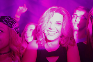 A concertgoer dances along at the Above and Beyond concert.