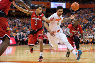 Gbinije loses control of the ball while driving the lane against UofL guard Quentin Snider.