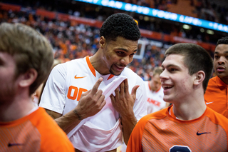 Gbinije and freshman Mike Sutton enjoy a laugh after Syracuse upset No. 12 Louisville, 69-59.