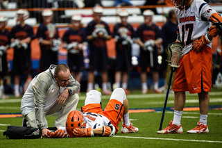 Donahue looks on as a trainer tends to a Syracuse player. 