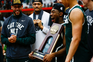 Michigan State shows off the team's NCAA East Regional trophy following the game. 