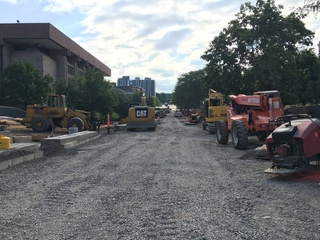Several construction vehicles line University Place. Gravel for the soon-to-be promenade has been placed, but paving has not yet begun. Photo taken July 22, 2016