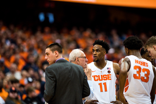 Syracuse players regroup during a timeout on Saturday in a thunderous environment. 